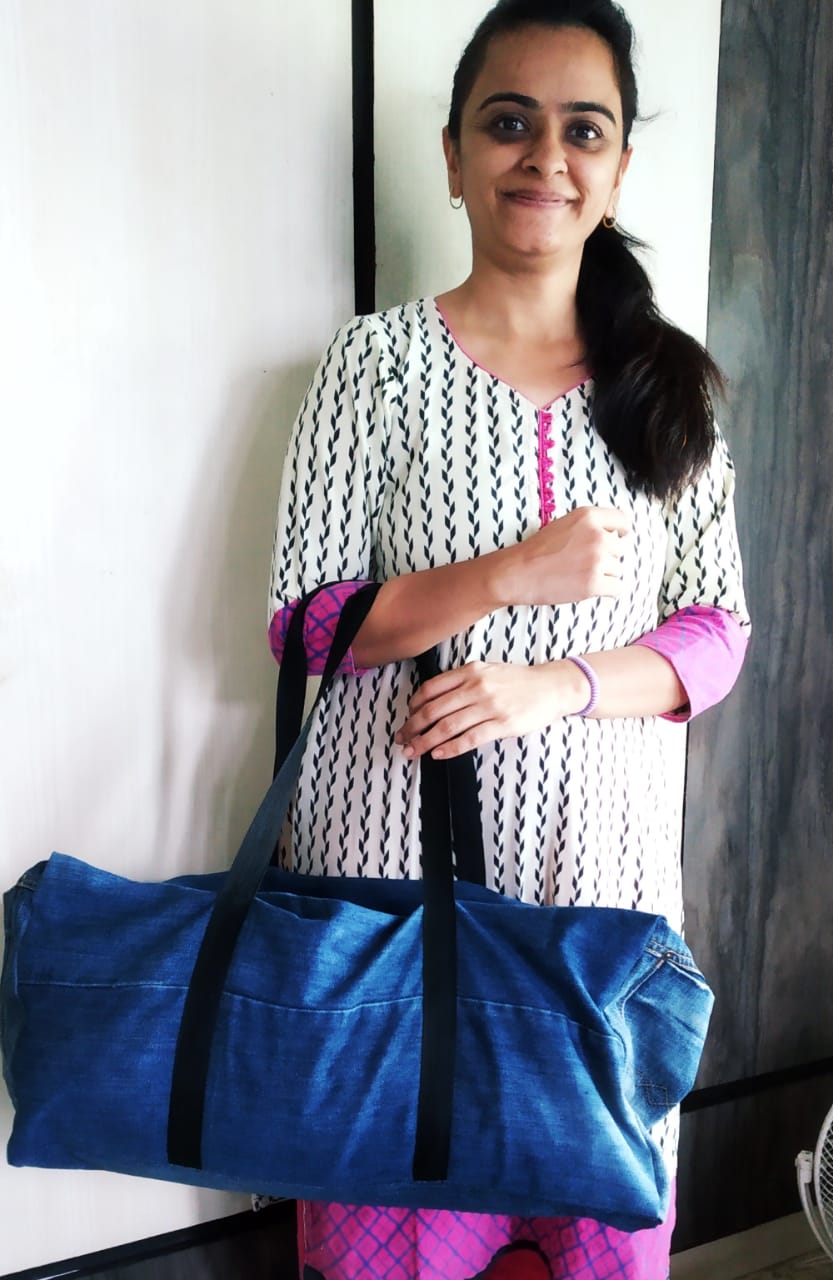 Customer holding a large upcycled denim duffle bag