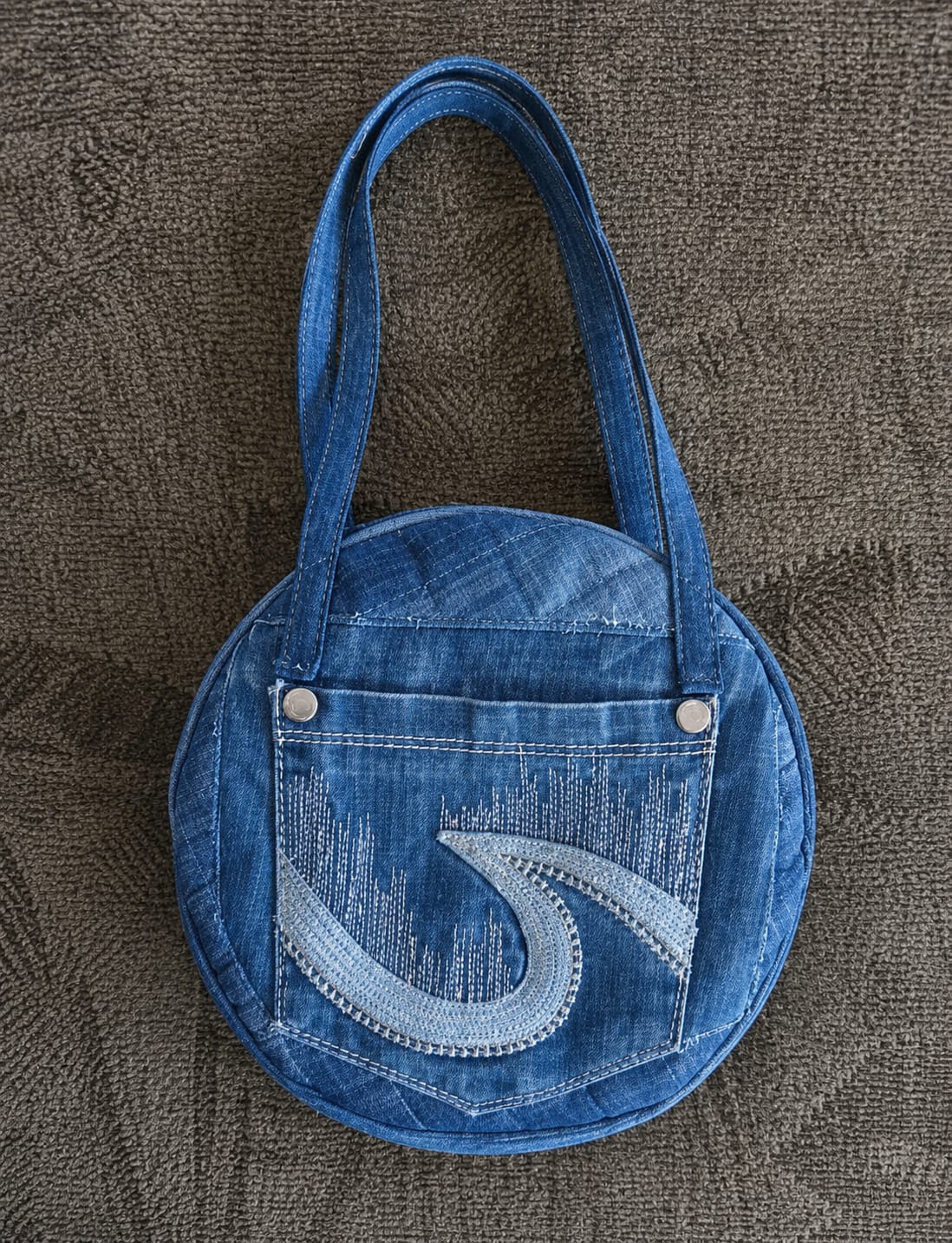 Round denim handbag with jeans pocket and embroidery detail